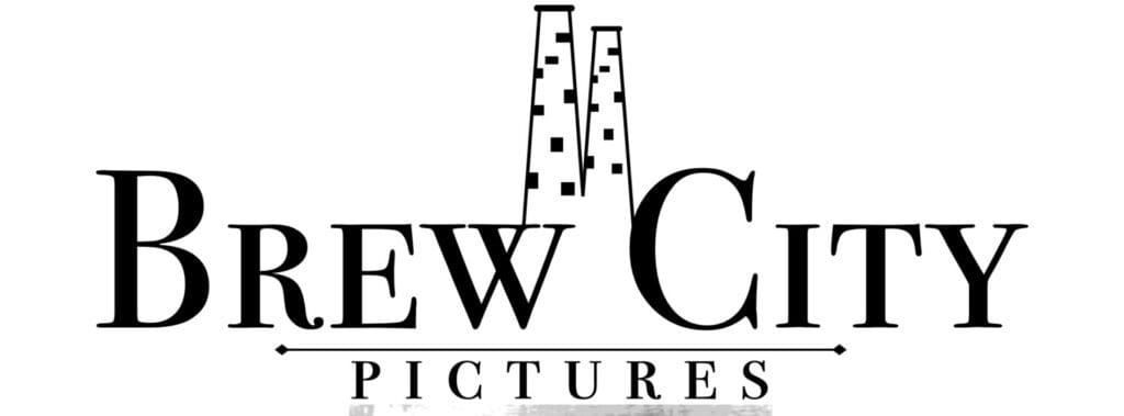 Logo with two tall factory chimneys and text 'EW C PICTURES'.
