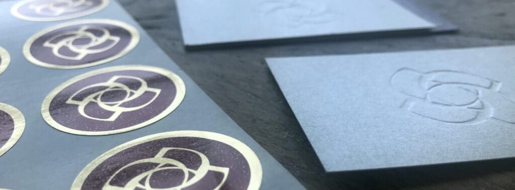 Close-up of cornered paper sheets and a decorative floral design.