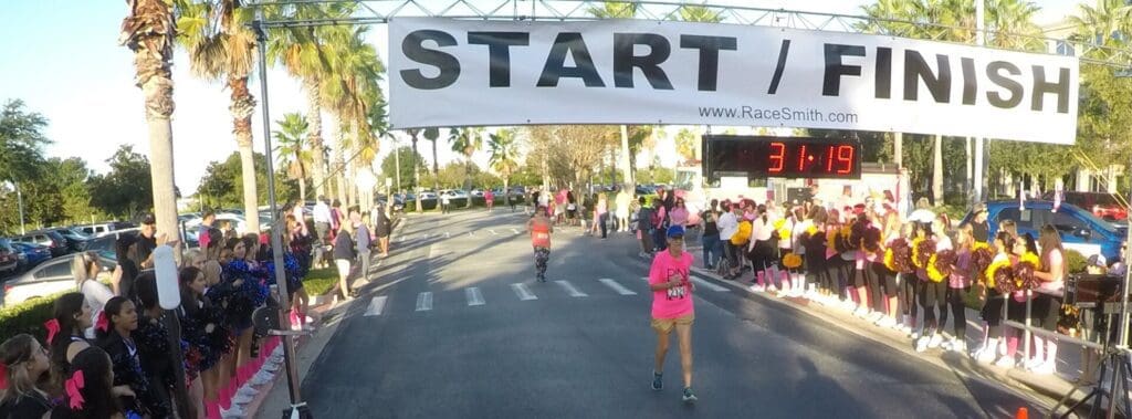 Runners begin a race at the starting line under a large START banner.